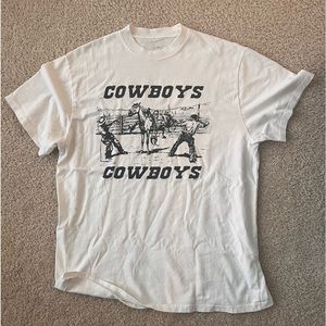 John Galt White T Shirt w/ “Cowboys, Cowboys” Graphic